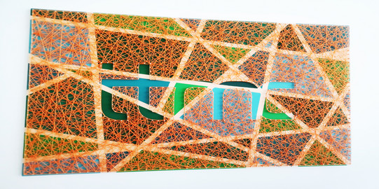 Orange threads to an ITMC logo stretched over a canvas.